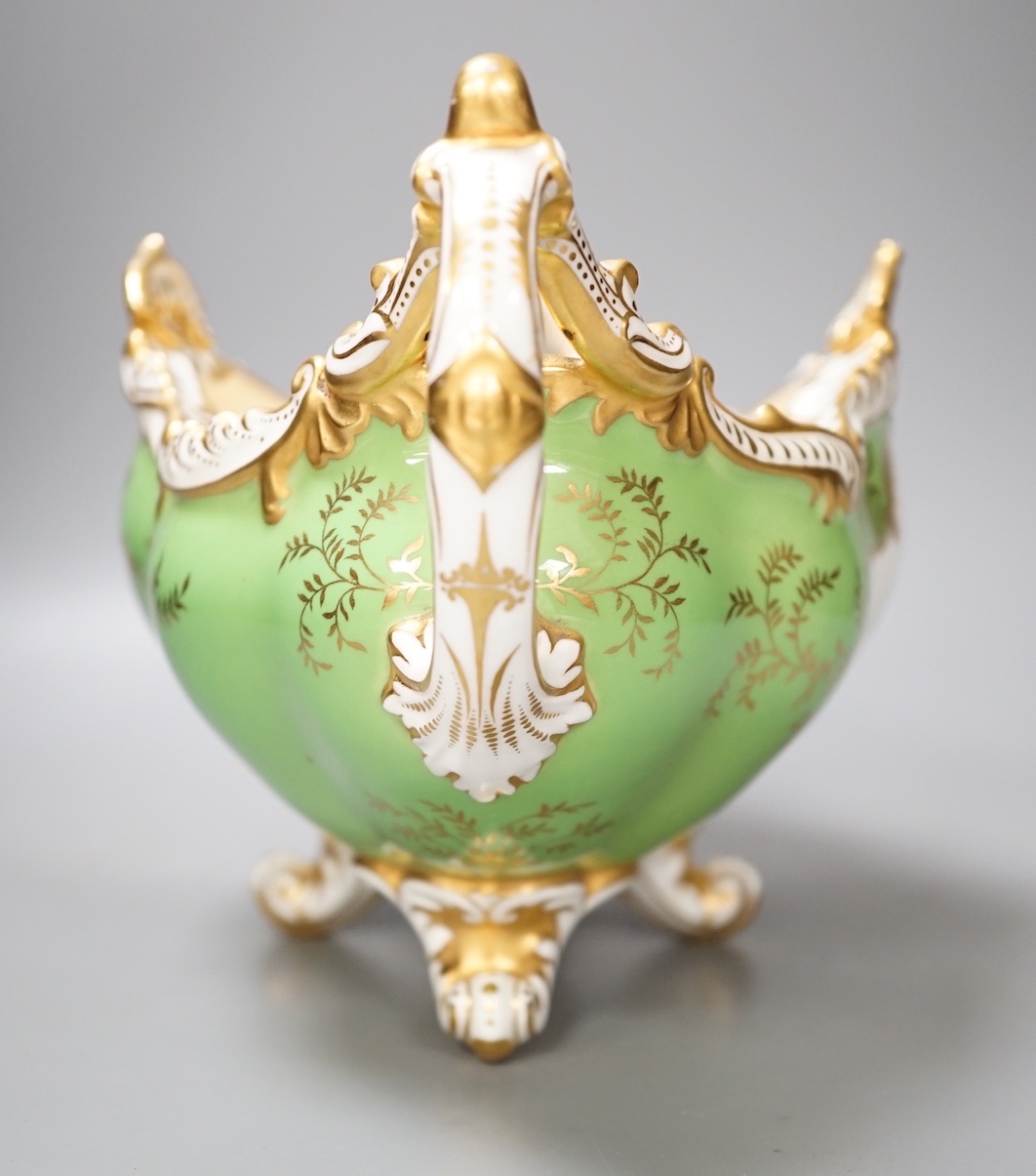 A Coalport twin handled boat shaped vase painted with a bird in panel on a lime green ground, c. 1900, 33cm